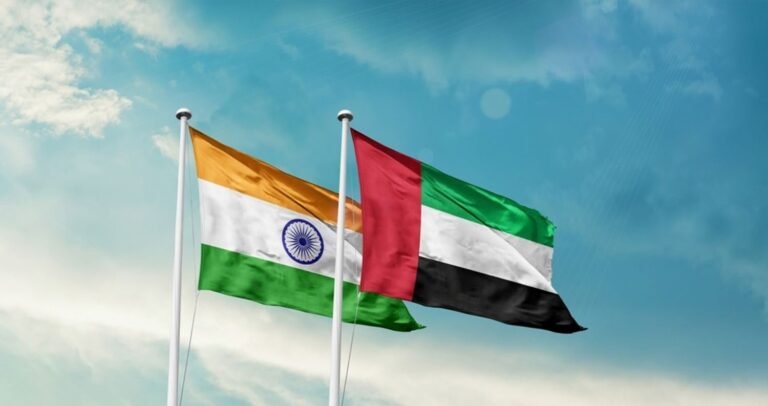 “Indian and UAE flags overlayed on a background of housing construction, symbolizing India–UAE collaboration on Australian housing project.”