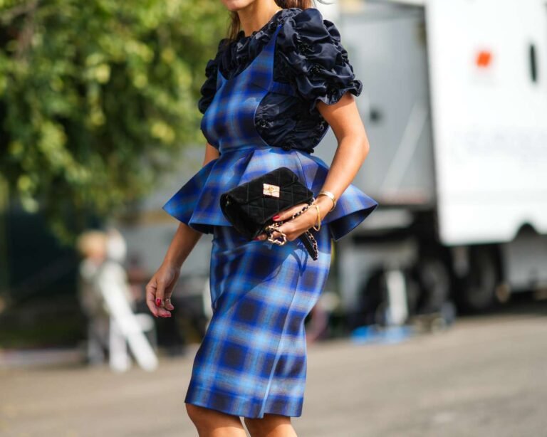Stylish individual wearing a structured peplum top paired with contemporary trousers.