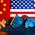 Stack of rare-earth mineral samples with U.S. and China flags in background
