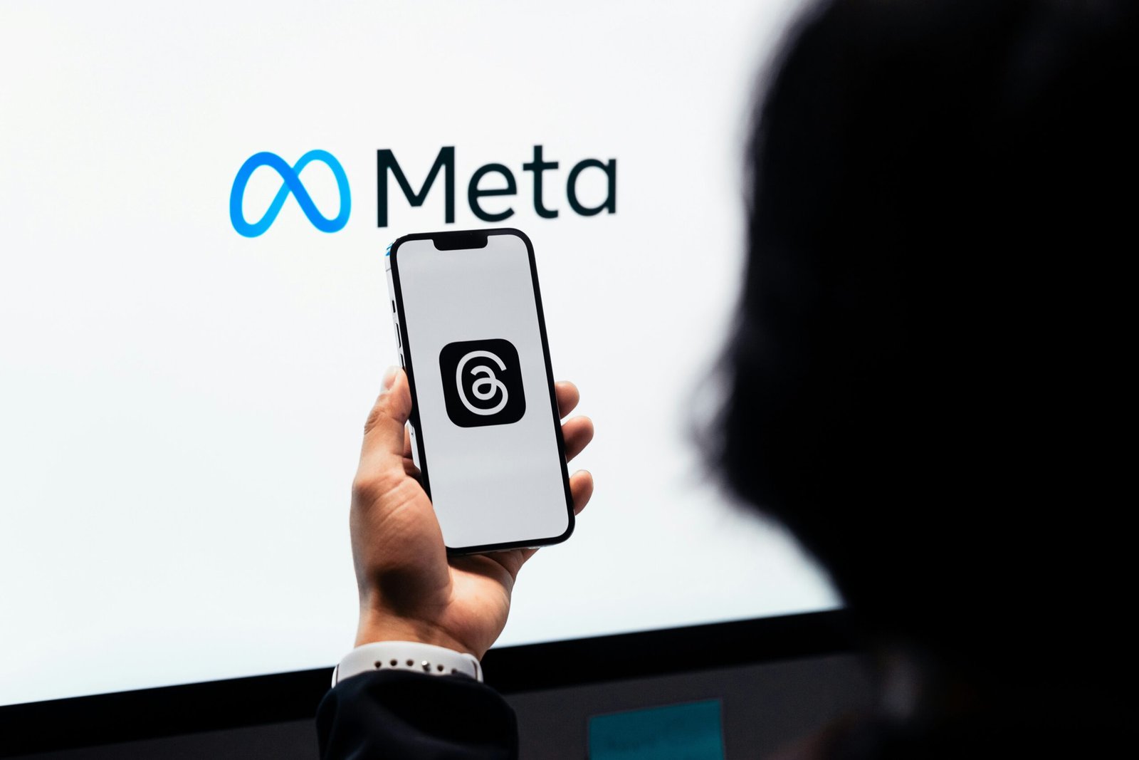 Meta logo with AI digital graphics representing the Manus acquisition