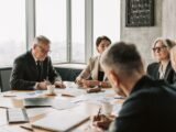 How AI Agents Are Reshaping the Corporate Hierarchy 17 AI agents reshaping corporate hierarchy in a modern enterprise boardroom